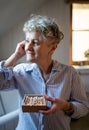 Senior woman in bathroom using ear cleaning sticks at home, ecologic and sustainable lifestyle. Royalty Free Stock Photo