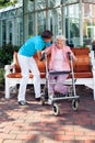 Senior woman being helped by a care assistant.