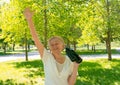 Senior woman with binoculars in park