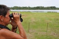 Senior woman birdwatching 1