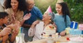 Senior woman, birthday cake and family in garden with applause, celebration and happy together for party. Man, women and Royalty Free Stock Photo