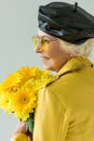 senior woman with bouquet of yellow flowers Royalty Free Stock Photo