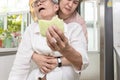 Senior woman with bread stuck in her throat,suffocating due to food clogging the trachea,obstruction of the airway,caregiver doing Royalty Free Stock Photo