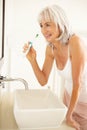 Senior Woman Brushing Teeth In Bathroom Royalty Free Stock Photo