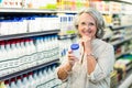 Senior woman buying milk Royalty Free Stock Photo