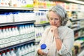 Senior woman buying milk Royalty Free Stock Photo