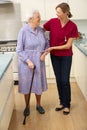 Senior woman and carer in kitchen