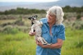 Senior Woman Carrying her Pet Dog Royalty Free Stock Photo