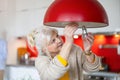 Senior woman changing light bulb in her home Royalty Free Stock Photo