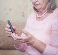 Senior woman checking blood sugar level using glucometer. Closeup hand of old person with diabetes. Diabetes treatment for elderly Royalty Free Stock Photo