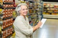 Senior woman checking list at the supermarket Royalty Free Stock Photo