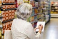 Senior woman checking list at the supermarket Royalty Free Stock Photo