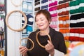 Senior woman choosing embroidery hoops for fancywork