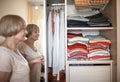 Senior woman choosing outfit from wardrobe. Cleaning, organizing and order in the closet Royalty Free Stock Photo