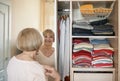 Senior woman choosing outfit from wardrobe. Cleaning, organizing and order in the closet Royalty Free Stock Photo