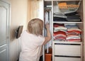 Senior woman choosing outfit from wardrobe. Cleaning, organizing and order in the closet Royalty Free Stock Photo