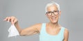 Senior woman cleaning hands and dropping wet wipes - care for health and prevention of infectious diseases Royalty Free Stock Photo