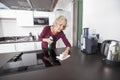 Senior woman cleaning kitchen counter Royalty Free Stock Photo