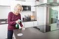 Senior woman cleaning kitchen counter Royalty Free Stock Photo