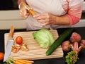 Senior woman or closeup with salad in kitchen and cutting, tomato and carrots for diet. Female chef and zoom with Royalty Free Stock Photo