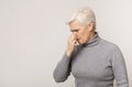 Senior woman closing nose because of bad smell Royalty Free Stock Photo