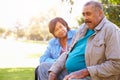 Senior Woman Comforting Unhappy Senior Husband Outdoors