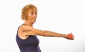 Senior Woman Concentrating On Lifting One Arm With Dumbbell