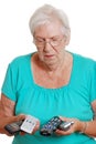 Senior woman confused with so many remote controls