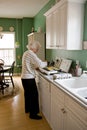 Senior woman cooking breakfast Royalty Free Stock Photo