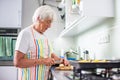 Senior woman cooking in the kitchen Royalty Free Stock Photo
