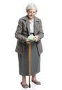 Senior woman counting money standing on white Royalty Free Stock Photo