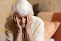 Senior woman holding head in hands in despair Royalty Free Stock Photo