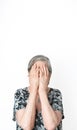 Senior woman covering her face with her hands deformed because of rheumatoid arthritis. Isolated white background Royalty Free Stock Photo