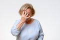 Senior woman covering her face with her hand Royalty Free Stock Photo