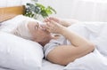 Senior woman covering nose with tissue while sneezing at home Royalty Free Stock Photo