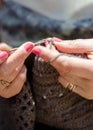 Senior woman crocheting a brown blanket relaxing in garden Royalty Free Stock Photo