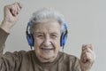 Senior woman dancing while listening music with headphones