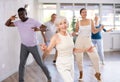 Senior woman dancing vintage twist in modern dance studio