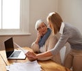 Senior woman, daughter and laptop with bills, finance and technology with advice and assistance. Help with online Royalty Free Stock Photo