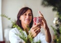 A senior woman decorating a Christmas tree at home. Royalty Free Stock Photo