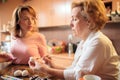 Senior woman decorating Easter eggs with her daughter Royalty Free Stock Photo