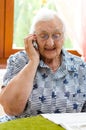 Senior Woman Dialling Number On Mobile Phone Royalty Free Stock Photo