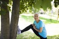 Senior woman does stretching exercise in the park Royalty Free Stock Photo