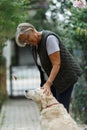 Senior woman with dog in spring nature, resting Royalty Free Stock Photo