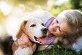 Senior woman with dog in spring nature, resting. Royalty Free Stock Photo