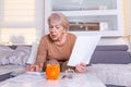 Senior woman doing finances at home. Senior woman with calculator and counting euro money at home. Business, savings, annuity Royalty Free Stock Photo