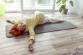 Senior woman doing spinal twist yoga exercise