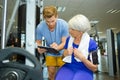 Senior woman doing sport exercises with coach or personal trainer Royalty Free Stock Photo