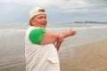 Senior woman doing sport to keep fit. Mature woman running along the shore of the beach. Concept of healthy life in the elderly. Royalty Free Stock Photo