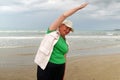 Senior woman doing sport to keep fit. Mature woman running along the shore of the beach. Concept of healthy life in the elderly. Royalty Free Stock Photo